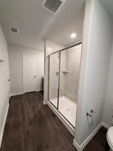 a bathroom with a glass shower door