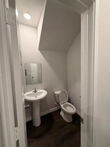 a white toilet sitting next to a bathroom sink