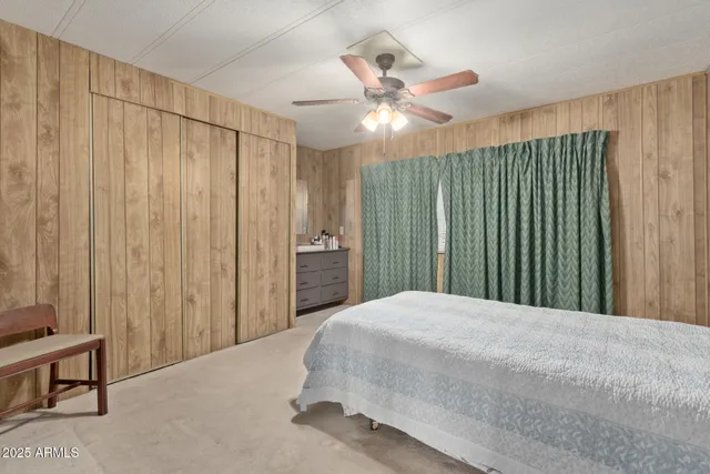 a bedroom with a large bed and a chandelier
