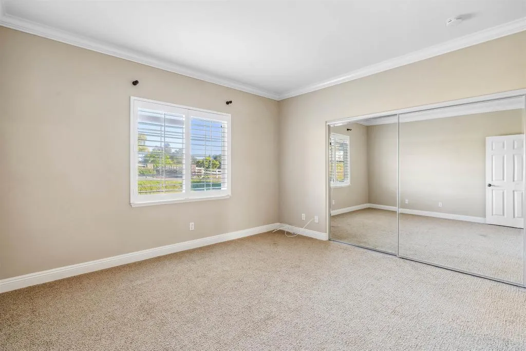 13371 Sage Meadow Lane, Unit 1 Valley Center, CA 92082 - Photo 16 of 38 an empty room with windows and closet