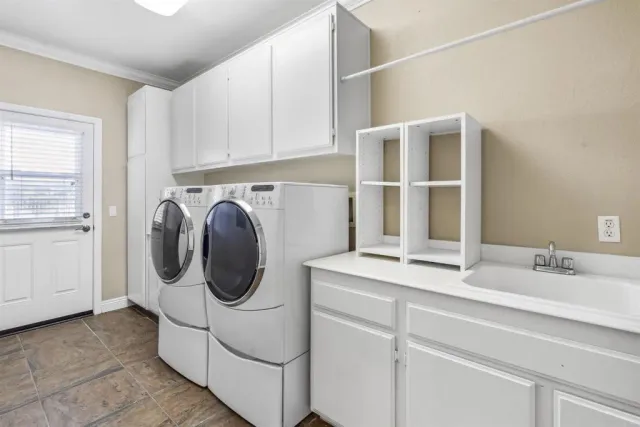 a utility room with sink dryer and washer
