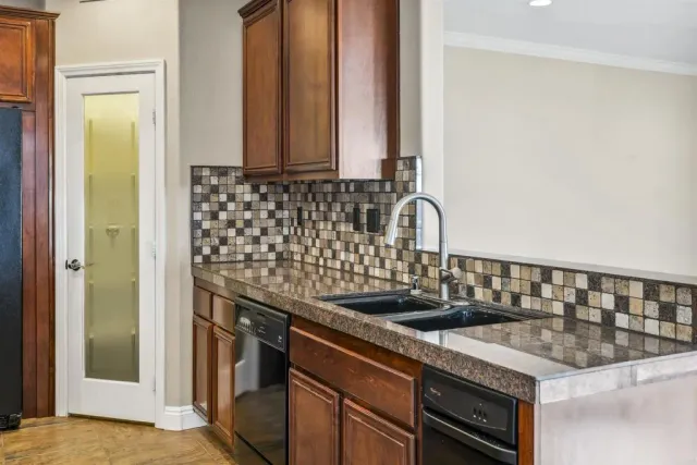a kitchen with granite countertop a sink and a stove