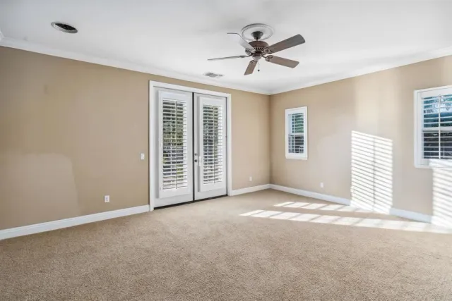 a view of a livingroom with a ceiling fan and window