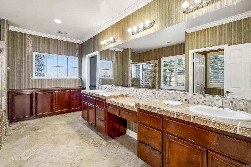 13371 Sage Meadow Lane, Unit 1 Valley Center, CA 92082 - Photo 30 of 38 a bathroom with a granite countertop double vanity sink and a mirror