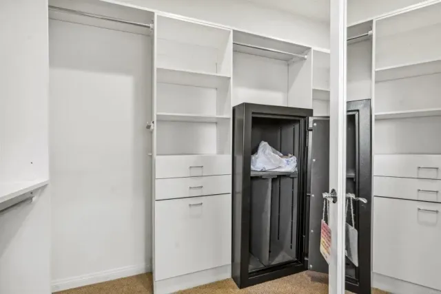 a view of a hallway with wooden floor and closet