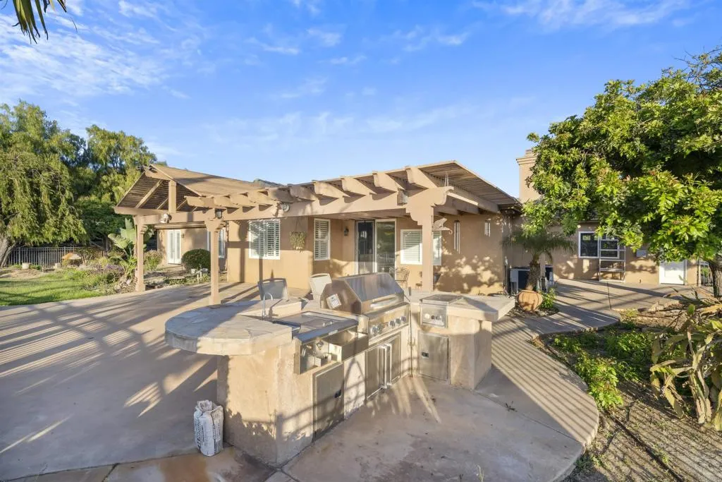 13371 Sage Meadow Lane, Unit 1 Valley Center, CA 92082 - Photo 33 of 38 a view of a patio with couches table and chairs and potted plants