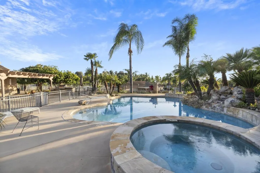 13371 Sage Meadow Lane, Unit 1 Valley Center, CA 92082 - Photo 37 of 38 a view of a swimming pool with a table and chairs