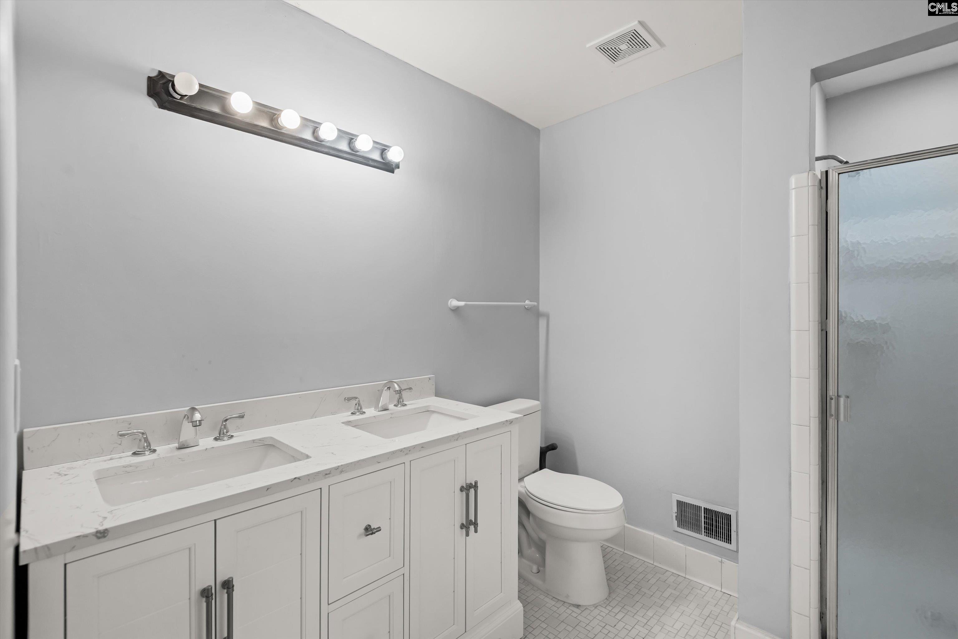 245 Piney Grove Road Columbia, SC 29210 - Photo 18 of 29 a bathroom with a toilet sink and mirror