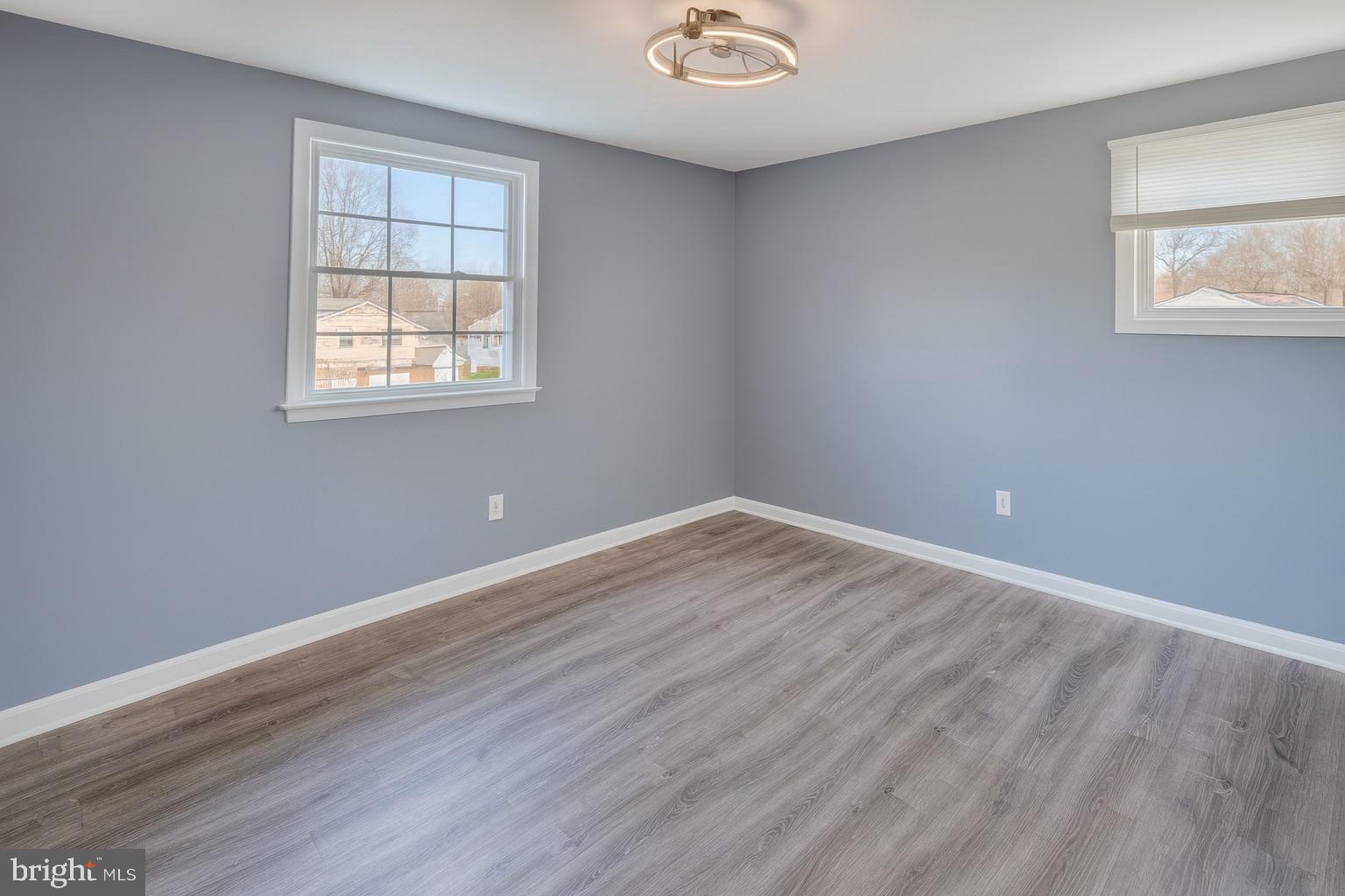 22 Clemson Road Cherry Hill, NJ 08034 - Photo 18 of 25 an empty room with wooden floor and windows
