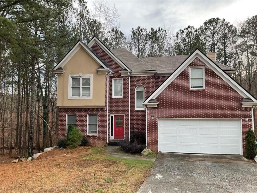 1217 Justin Lane Lithonia, GA 30058 - Photo 1 of 1 a front view of a house with a yard and garage