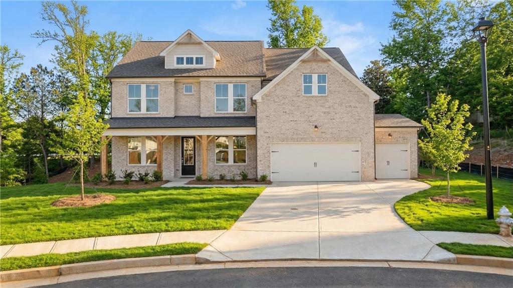 900 Melody Ridge Lane Buford, GA 30518 - Photo 1 of 30 a front view of a house with a yard and garage