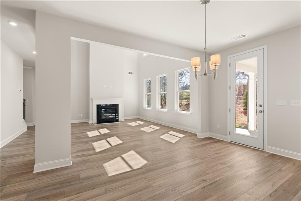 900 Melody Ridge Lane Buford, GA 30518 - Photo 11 of 30 a view of an empty room with window and wooden floor