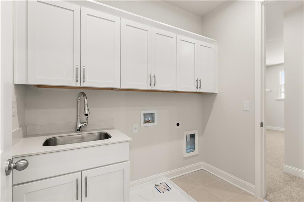 900 Melody Ridge Lane Buford, GA 30518 - Photo 25 of 30 a kitchen with a sink and cabinets