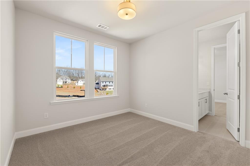 900 Melody Ridge Lane Buford, GA 30518 - Photo 26 of 30 an empty room with windows and view of kitchen