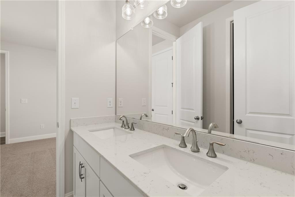 900 Melody Ridge Lane Buford, GA 30518 - Photo 29 of 30 a bathroom with 2 sink and a mirror