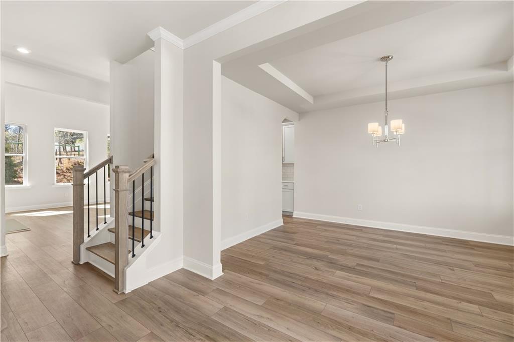 900 Melody Ridge Lane Buford, GA 30518 - Photo 7 of 30 a view of an empty room with wooden floor