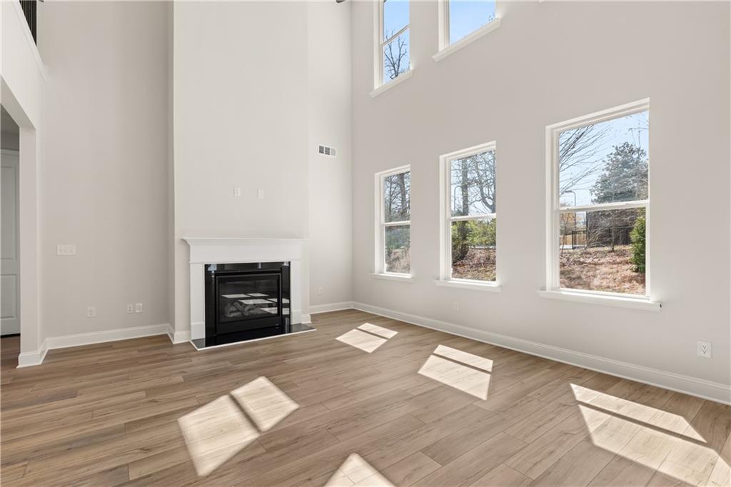 900 Melody Ridge Lane Buford, GA 30518 - Photo 9 of 30 an empty room with windows and fireplace