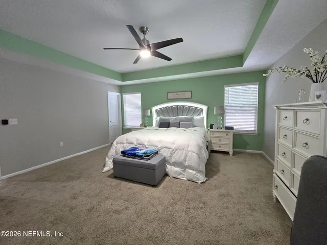 a bedroom with a bed and a chair