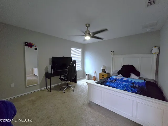 a bedroom with a bed and window