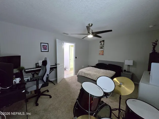 a living room with patio furniture and a floor to ceiling window
