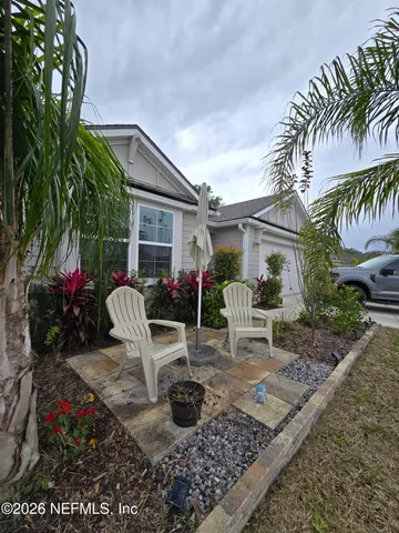 a view of a chair and table in backyard