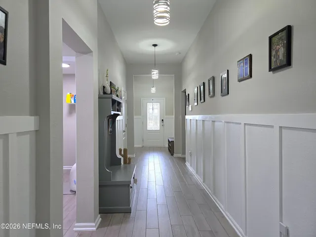 a living room with furniture a table and kitchen view