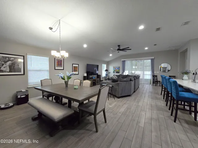 a large kitchen with a table and chairs