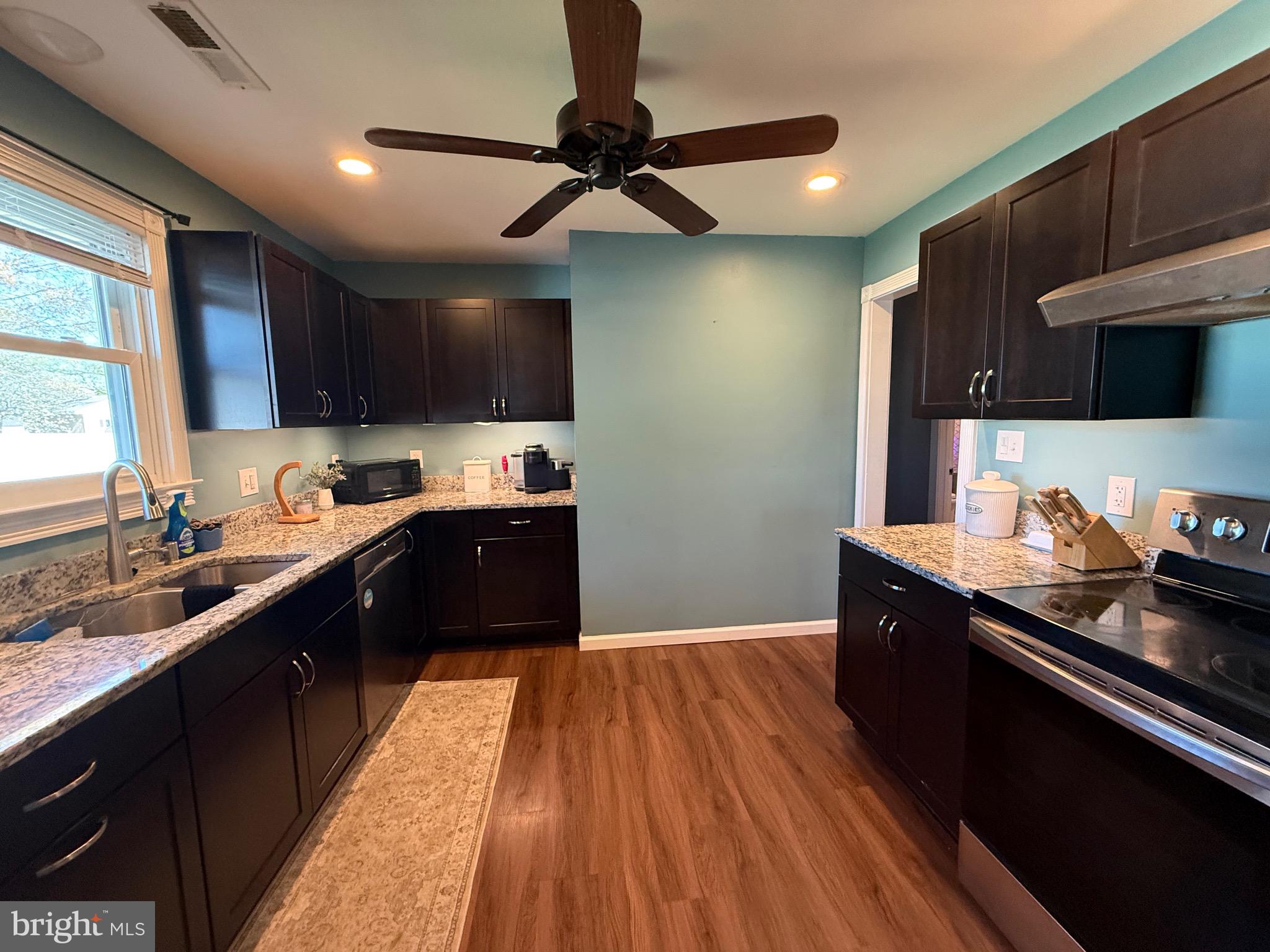 501 Chestnut Street Hebron, MD 21830 - Photo 11 of 30 a kitchen with granite countertop a sink cabinets and stainless steel appliances