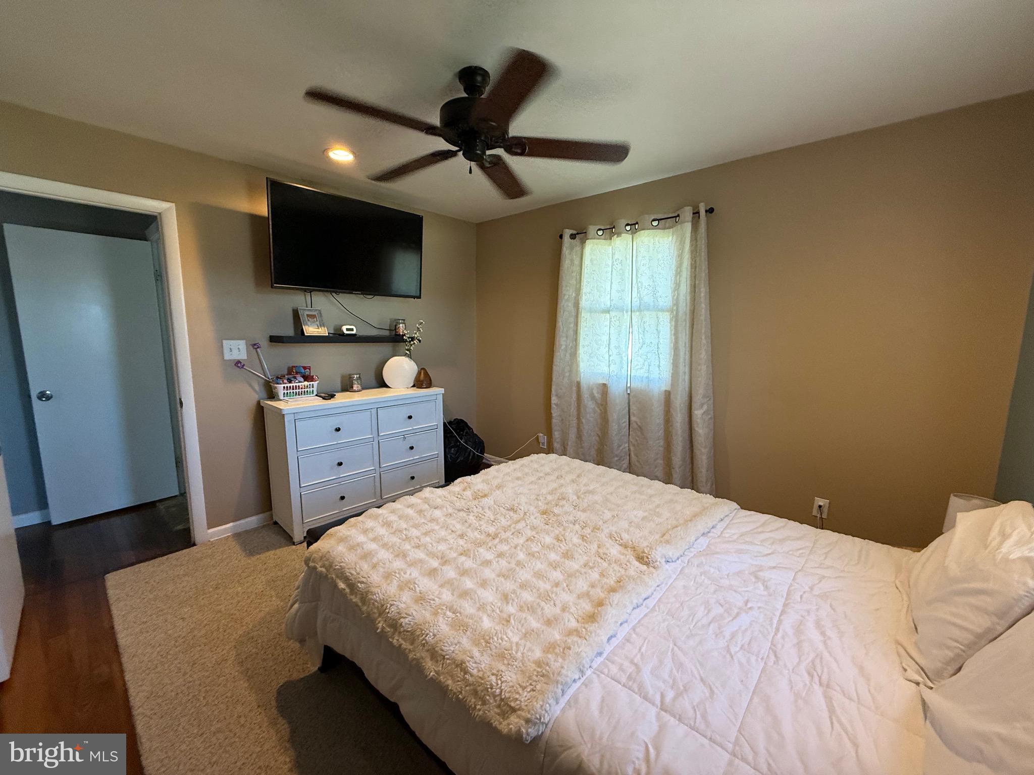 501 Chestnut Street Hebron, MD 21830 - Photo 20 of 30 a bedroom with a bed and a flat screen tv