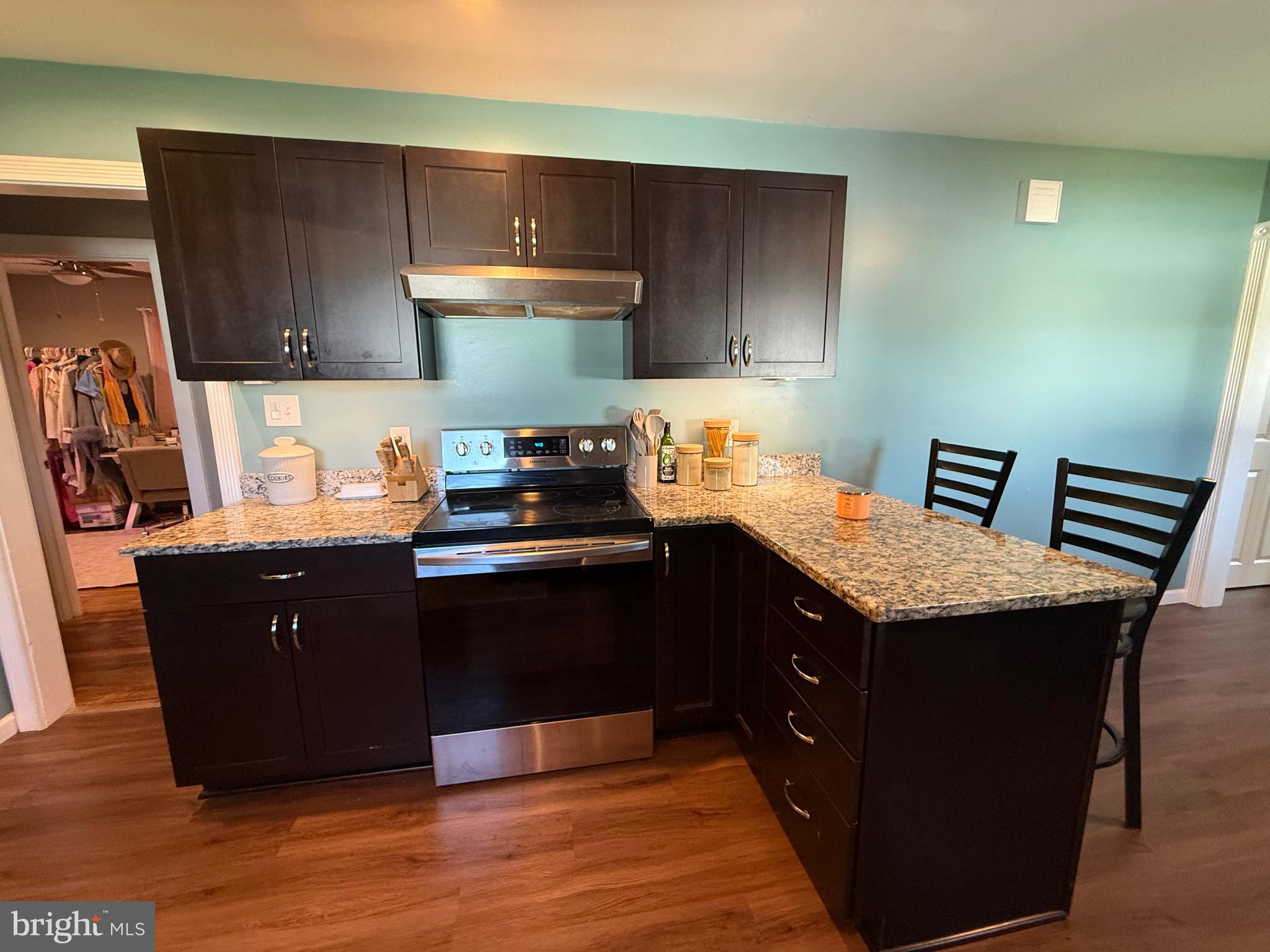 501 Chestnut Street Hebron, MD 21830 - Photo 10 of 30 a kitchen with granite countertop wood cabinets and a stove top oven