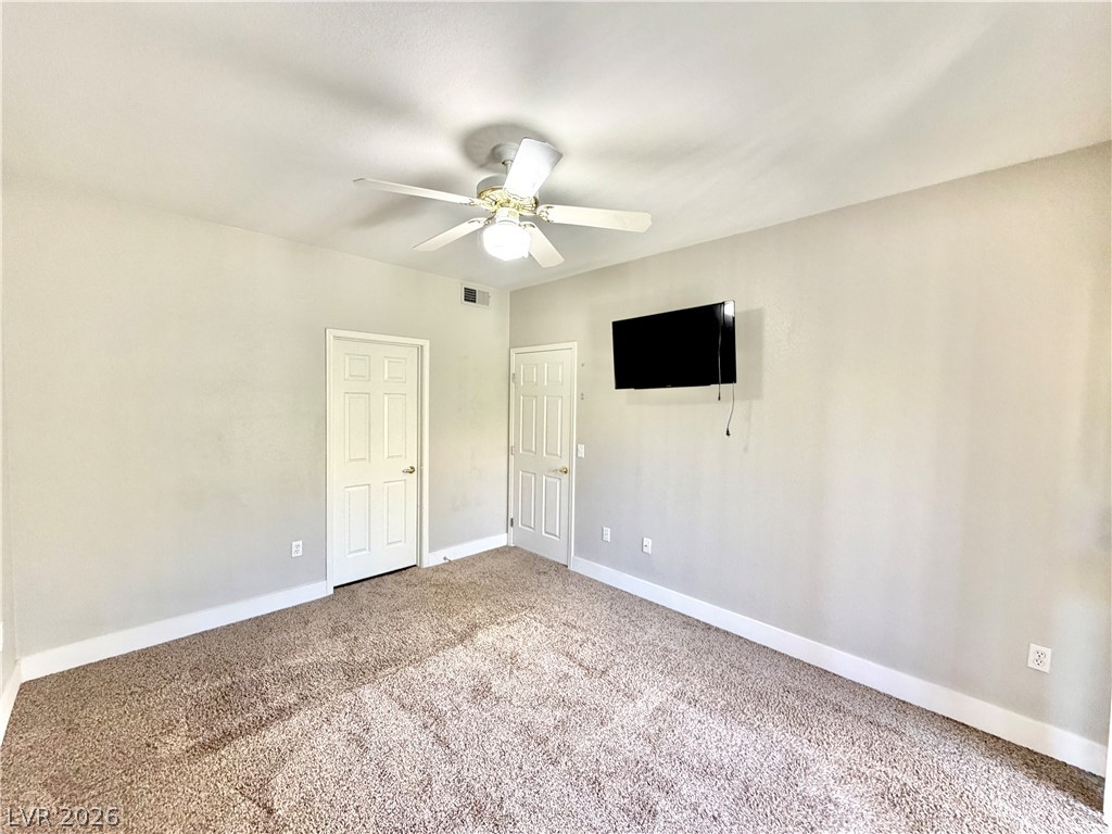8555 West Russell Road, Unit 2018 Las Vegas, NV 89113 - Photo 14 of 23 A comfortable bedroom with soft carpeting and two panel doors, perfect for peaceful repose.