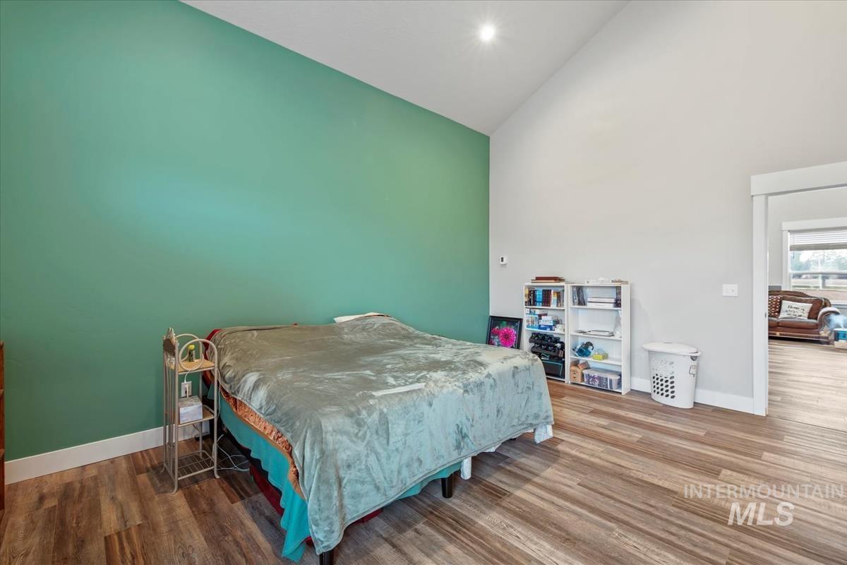 17322 Can-Ada Road Nampa, ID 83687 - Photo 18 of 44 Bedroom with high vaulted ceiling and wood finished floors