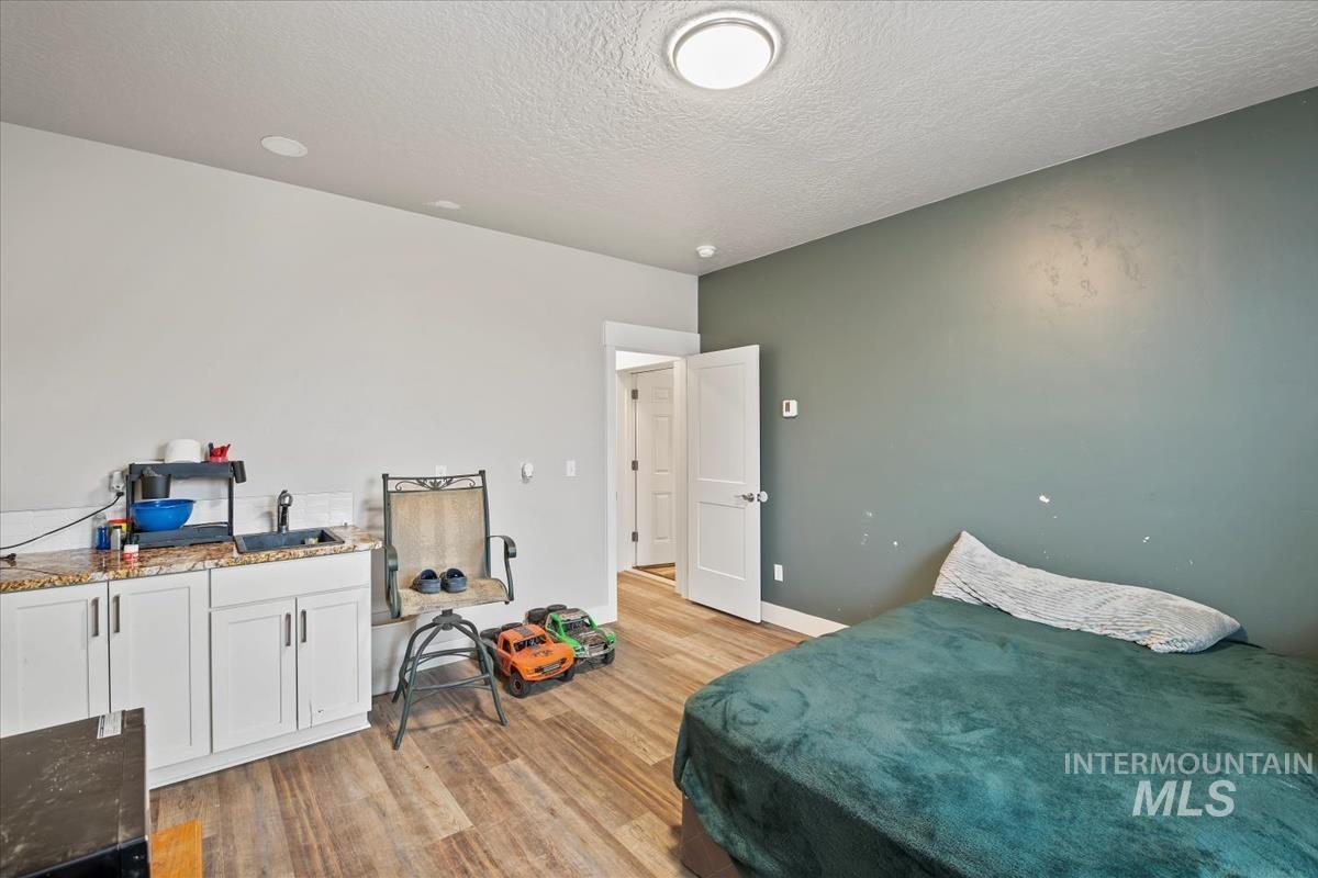 17322 Can-Ada Road Nampa, ID 83687 - Photo 20 of 44 Bedroom with a textured ceiling and light wood-style floors
