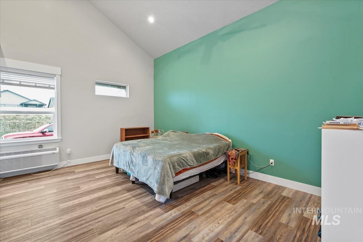 17322 Can-Ada Road Nampa, ID 83687 - Photo 21 of 44 Bedroom with wood finished floors, high vaulted ceiling, and a wall mounted AC