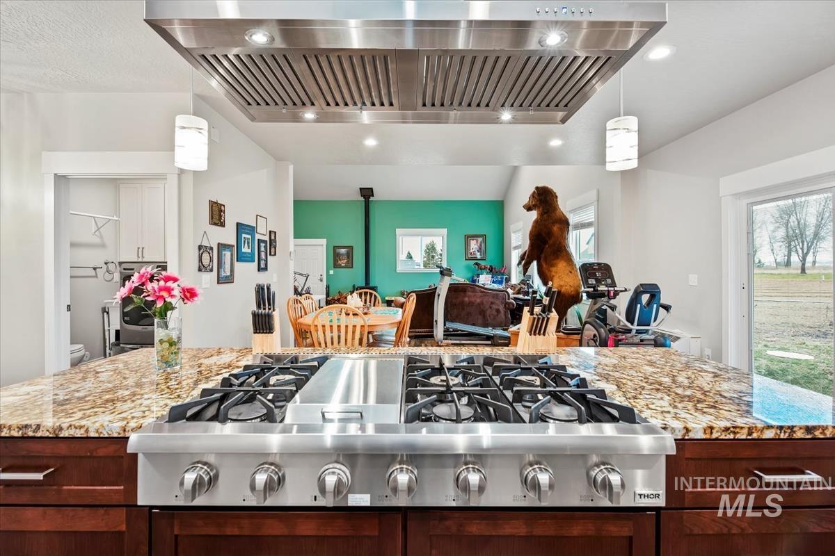 17322 Can-Ada Road Nampa, ID 83687 - Photo 25 of 44 Kitchen with exhaust hood, stainless steel gas stovetop, light stone countertops, decorative light fixtures, and recessed lighting