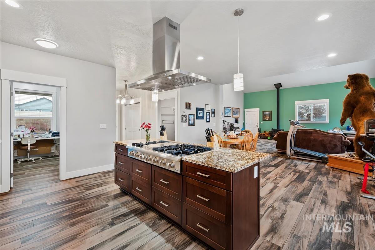 17322 Can-Ada Road Nampa, ID 83687 - Photo 28 of 44 Kitchen featuring healthy amount of natural light, decorative light fixtures, a kitchen island, a textured ceiling, and recessed lighting