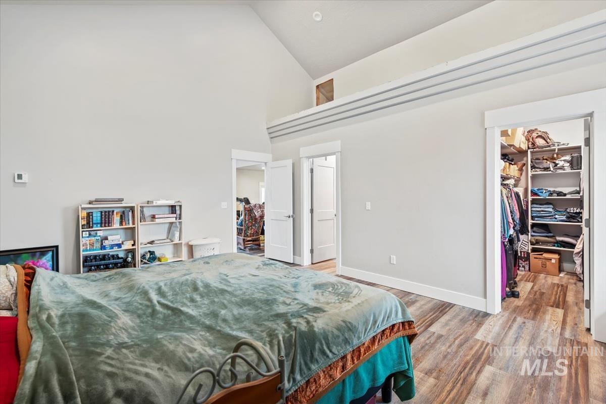 17322 Can-Ada Road Nampa, ID 83687 - Photo 30 of 44 Bedroom featuring a spacious closet, high vaulted ceiling, and wood finished floors