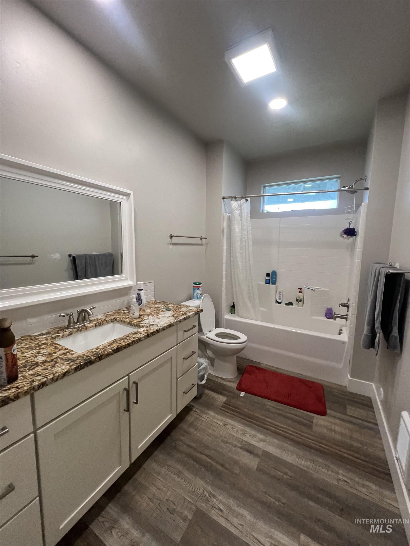 17322 Can-Ada Road Nampa, ID 83687 - Photo 41 of 44 Bathroom with shower / bath combo with shower curtain, vanity, and dark wood-style floors