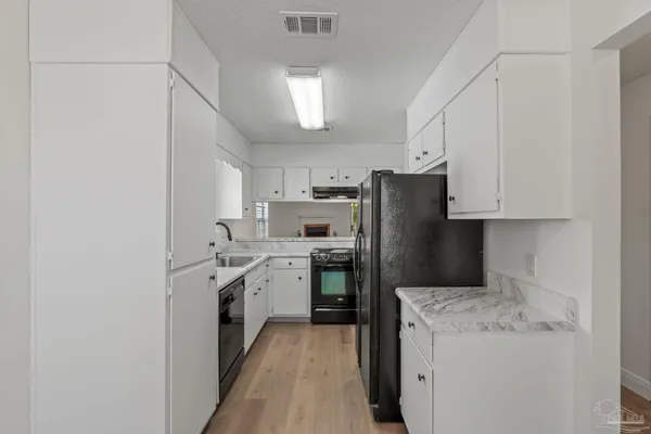 a kitchen with cabinets and stainless steel appliances