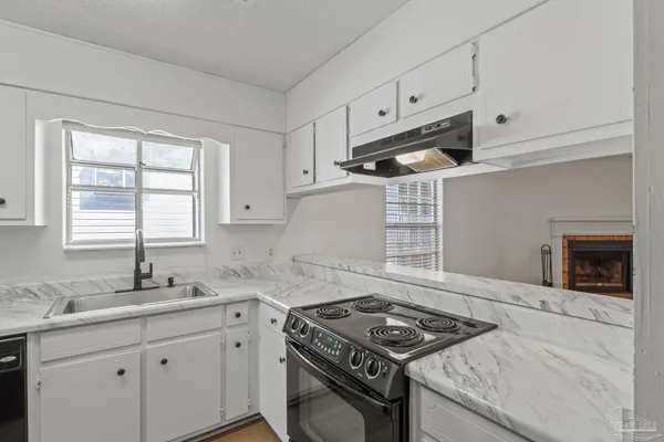 a kitchen with granite countertop cabinets stainless steel appliances and a sink