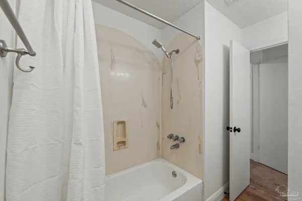 a bathroom with a tub and a shower