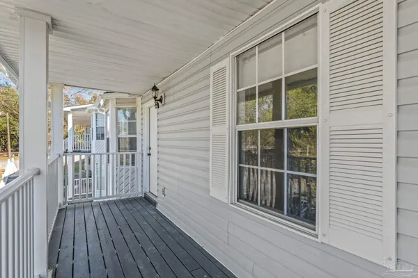 a view of wooden balcony with a door