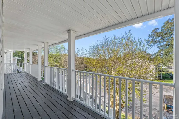a view of a balcony with wooden floor