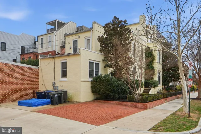 a view of a brick house with large windows