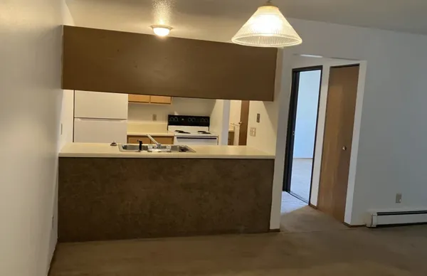 a kitchen with stainless steel appliances granite countertop a refrigerator a stove a microwave oven with white cabinets