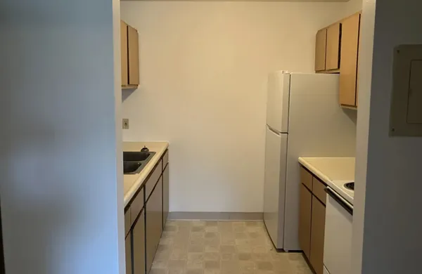 a kitchen with a refrigerator and cabinets