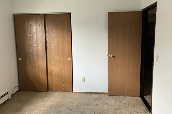 an empty room with closet area