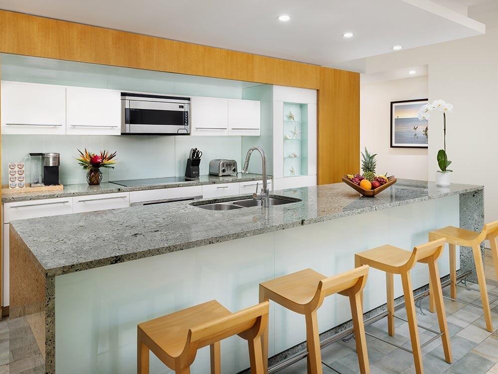 a kitchen with stainless steel appliances granite countertop a sink and a white cabinets
