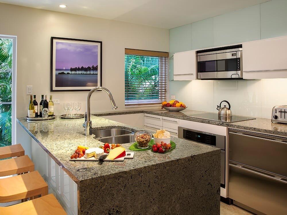 1401 Simonton Street, Unit 11 Key West, FL 33040 - Photo 2 of 17 a kitchen with a stove a sink and a microwave