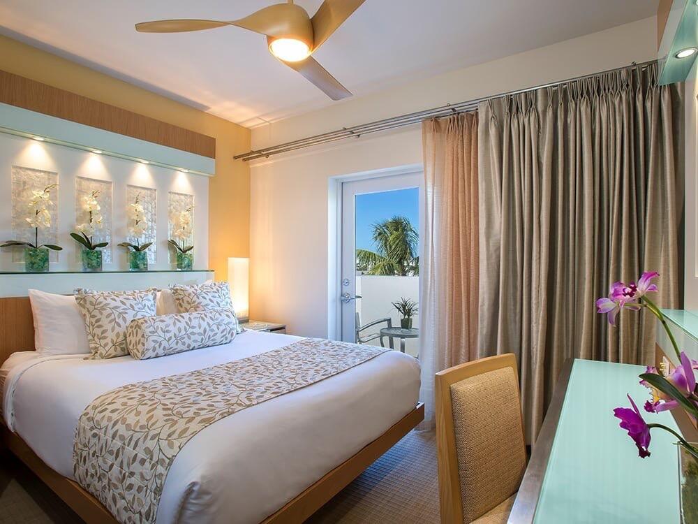 1401 Simonton Street, Unit 11 Key West, FL 33040 - Photo 6 of 17 a bedroom with a bed and a potted plant